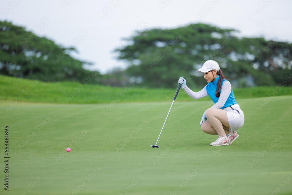 Obraz premium golfer asian women sitting hold golf club checking fairway and teeing golf in golf tournament competition at golf course,
