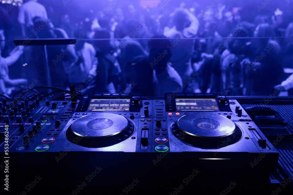 dj table in the club and people in the background Photos