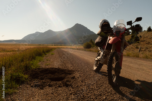 Backlit enduro motorcycle on mountain road