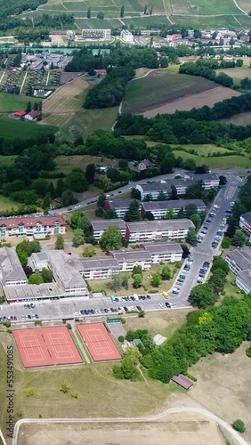 Vertical video of Aerial shot of low cost housings village, river and mountain background photo