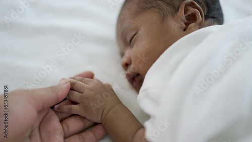 Parent hands holding newborn african black baby fingers, Close up mother's hand holding their new born baby. Together love family healthcare and medical, father's day and mother's day concept