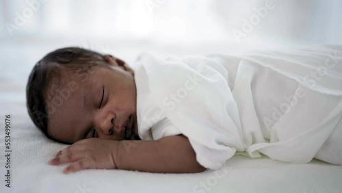 Closeup portrait of african happy baby sleeping sweet dream on bed over white background with copy space. Healthy newborn child take a nap asleep. Family love newborn healthcare medical concept.