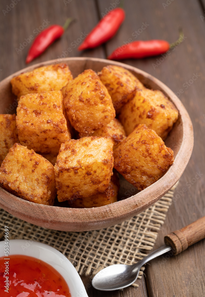 Tapioca dice, typical northeast brazilian food with chilli pepper syrup over wooden table Tapioca dice, typical northeast brazilian food with chilli pepper syrup over wooden table