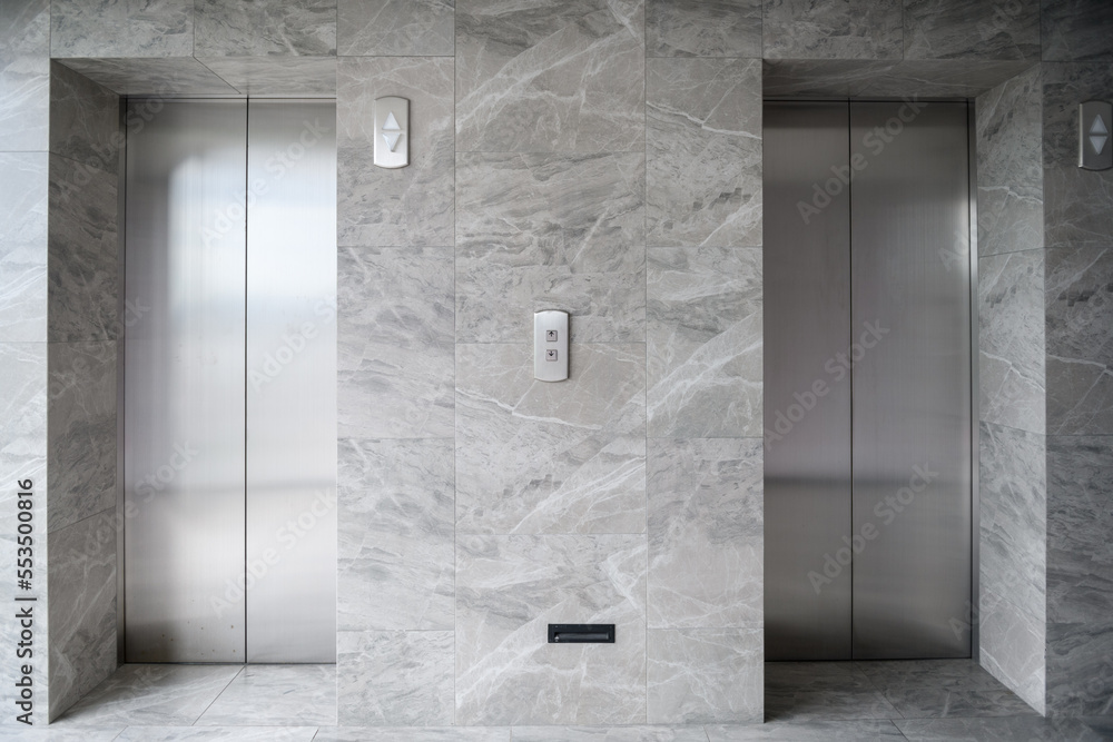 © Jirawatfoto - modern metal elevators in hotel lobby