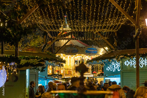 Vigo, Spain - December 05, 2022: Christmas lights decoration, with tourists walking through its streets in the city of Vigo, Pontevedra, Spain