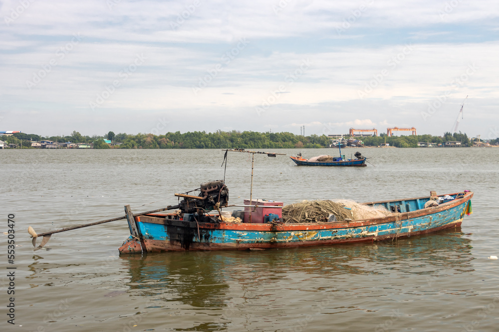 Fishing boats loaded with nets is moor on the Chao Phraya River, Thailand