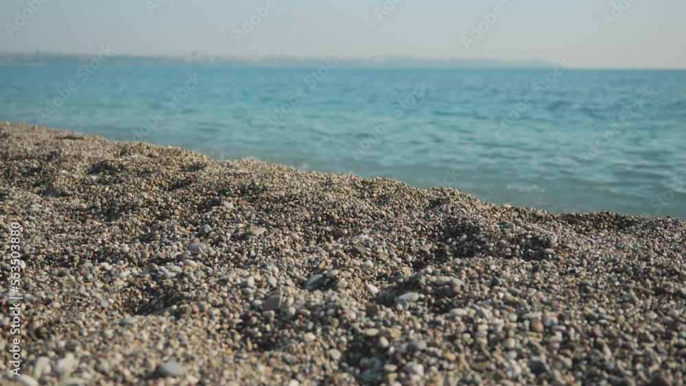 A part of an empty sea small-stony small-pebble beach for the background to a video about a vacation at sea. High quality 4k footage