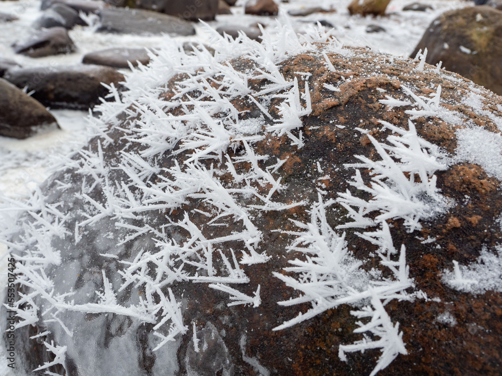 Ice and snow crystals grown on the surface of the stone after a hard frost Ice and snow crystals grown on the surface of the stone after a hard frost