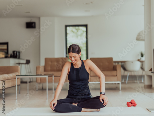 Young Beautiful Female Exercising, Stretching and Practising Yoga with Trainer via Video Call Conference in Bright Sunny House. Healthy Lifestyle, Wellbeing and Mindfulness Concept.