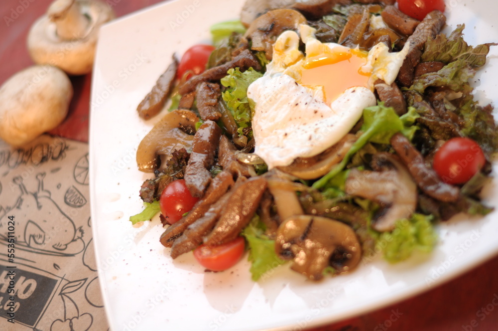 restaurant dish for the holidays, salad with poached egg restaurant dish for the holidays, salad with poached egg