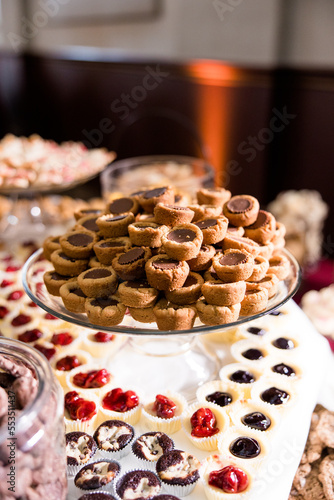 Peanut butter blossom cookies with peanut butter cups on a dessert table