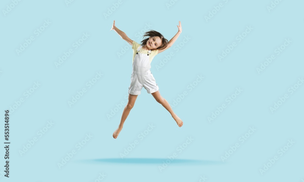 Energetic cute child jumping and posing