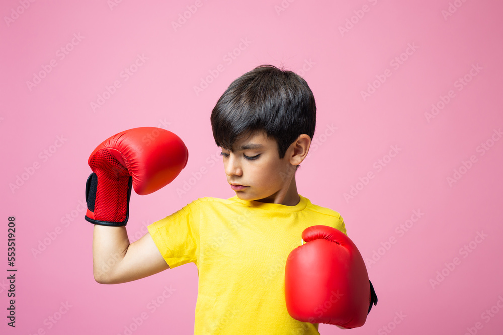 Boy with boxing gloves showing off muscle Boy with boxing gloves showing off muscle