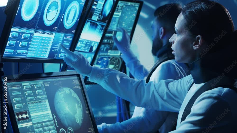 Team of astronauts in a space suits aboard the orbital station. A crew of cosmonauts piloting the spaceship. Man and woman in space. Galactic travel and science concept. Team of astronauts in a space suits aboard the orbital station. A crew of cosmonauts piloting the spaceship. Man and woman in space. Galactic travel and science concept.