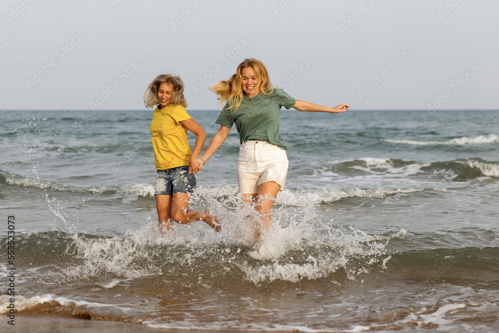 Girlfriends walk and have fun at the sea, family vacation at sea Girlfriends walk and have fun at the sea, family vacation at sea