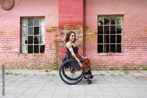 Young determined woman with paraplegia smiling.