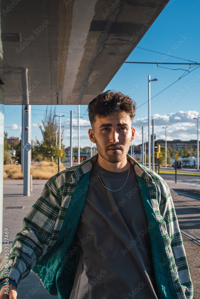 Male student waiting for the tram