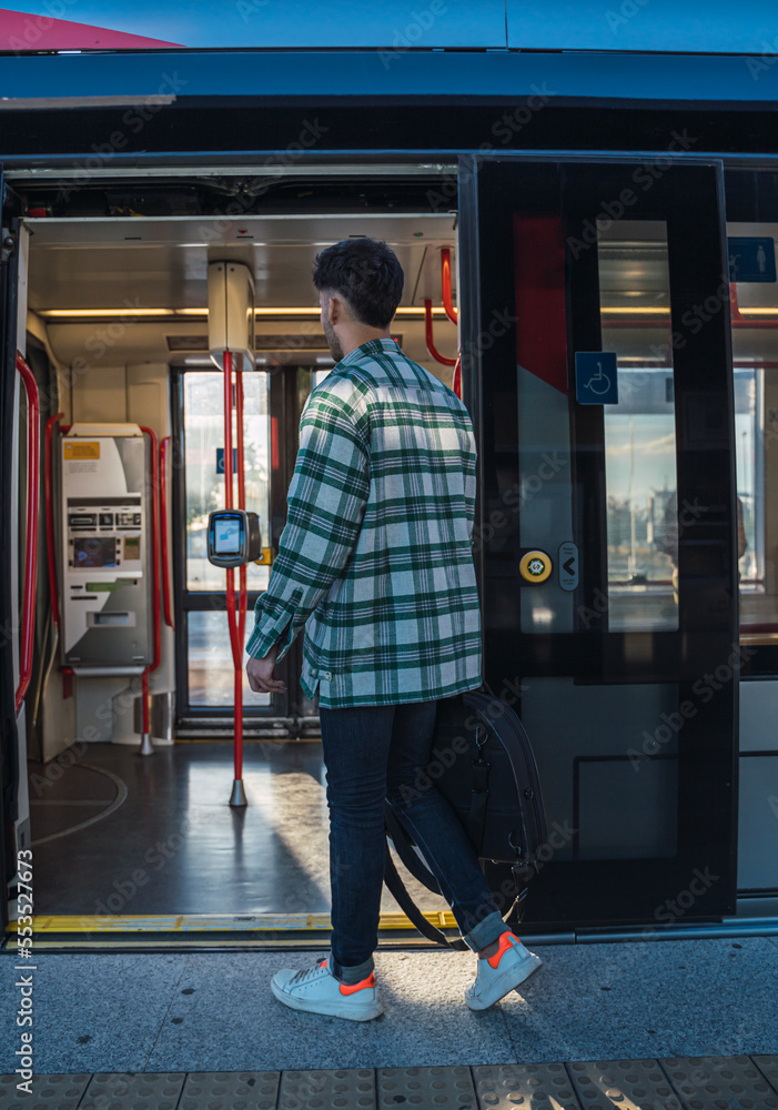 Male student waiting for the tram