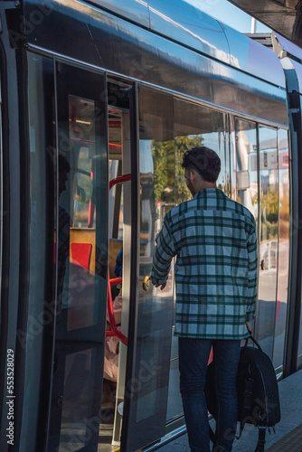 Obraz na płótnie Male student waiting for the tram w salonie