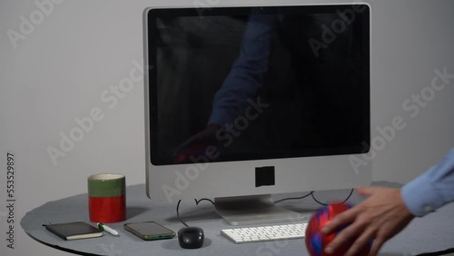 The soccer ball is repeatedly thrown at a workstation's computer monitor - 
children's ball breaks the monitor photo