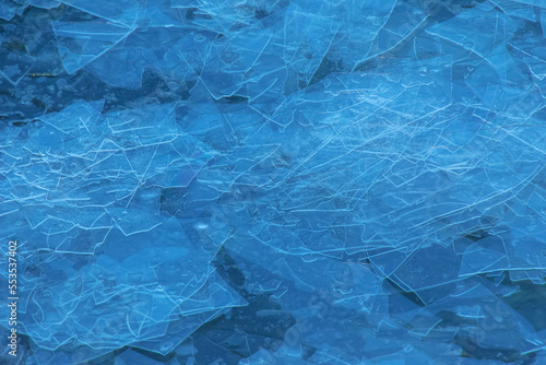Ice surface of the river. Texture of ice shards. Winter background.