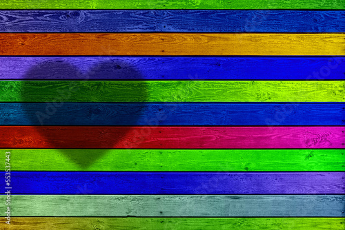 background of horizontal multi-colored wooden planks with a silhouette of a heart