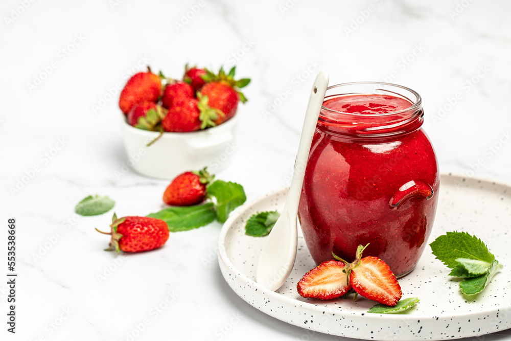 strawberry jam in a jar and fresh berries on white table. banner, menu, recipe place for text strawberry jam in a jar and fresh berries on white table. banner, menu, recipe place for text