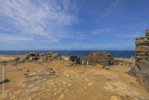 Beautiful historical view of Atlantic ocean with ruins of gold smelter in Bushiribana. Aruba island.