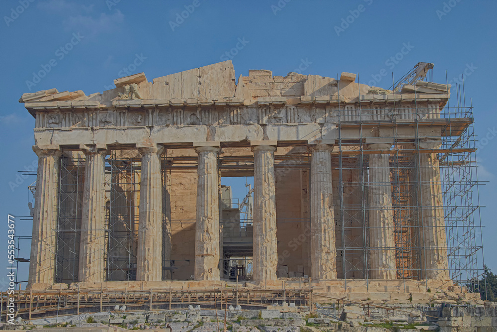 The western main front of Parthenon ancient temple under a clear blue sky as a background. A visit to Acropolis of Athens, Greece.