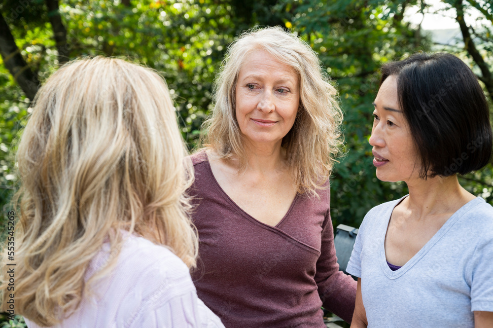 Small group of senior ladies chatting outdoors Small group of senior ladies chatting outdoors
