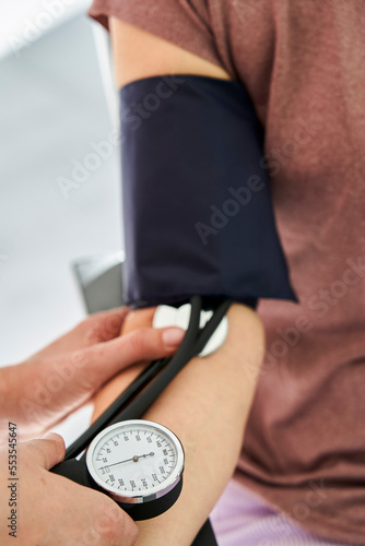 Close-up of person measuring blood pressure