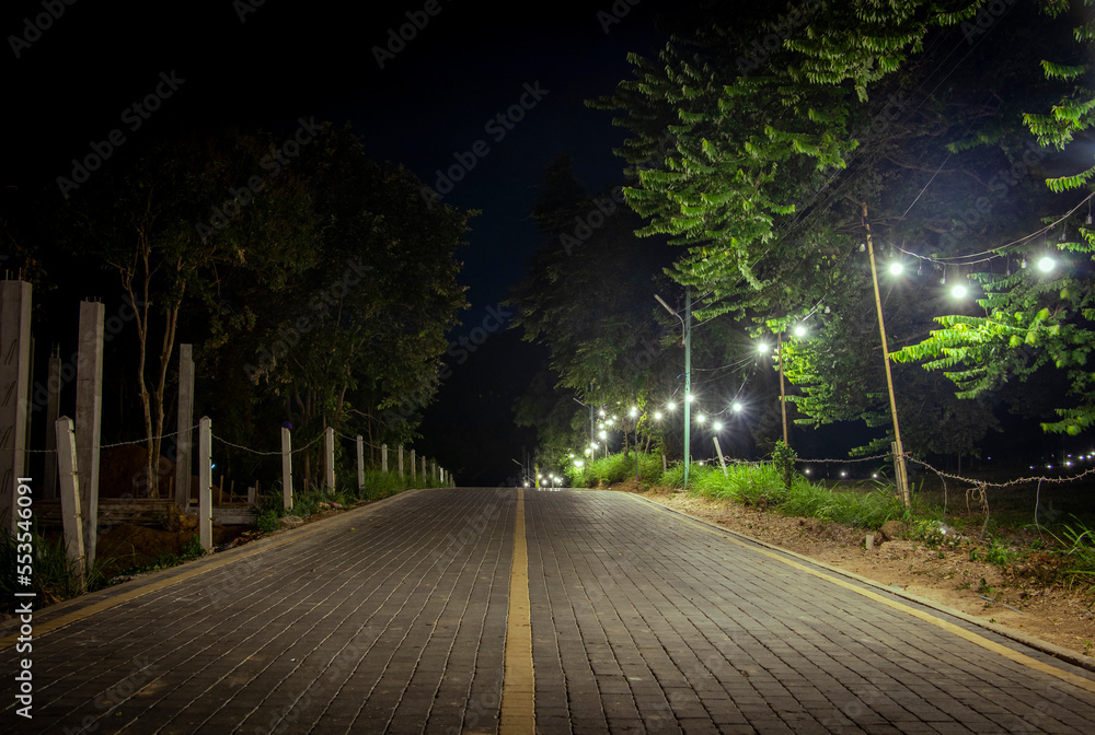 brick road with light bulbs at night