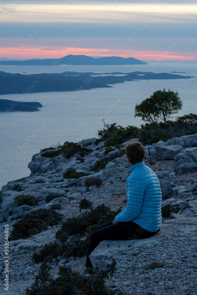 A woman staring into the distance on the top of the highest mountain of the island of Brač.