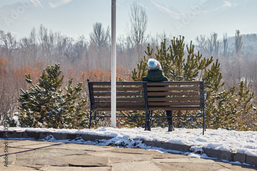 woman sitting on a bench in park