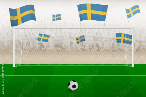 Sweden football team fans with flags of Sweden cheering on stadium, penalty kick concept in a soccer match.