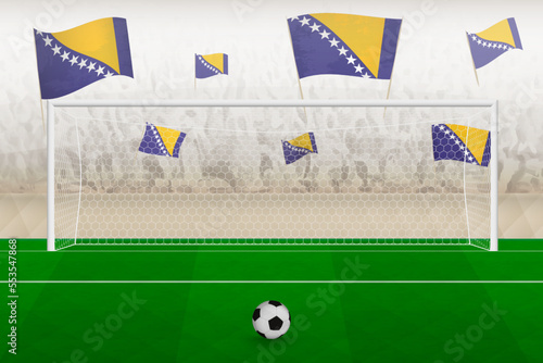 Bosnia and Herzegovina football team fans with flags of Bosnia and Herzegovina cheering on stadium, penalty kick concept in a soccer match.