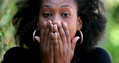 African woman reacting with SHOCK and SURPRISE