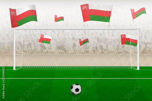 Oman football team fans with flags of Oman cheering on stadium, penalty kick concept in a soccer match.