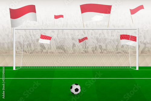 Indonesia football team fans with flags of Indonesia cheering on stadium  penalty kick concept in a soccer match.