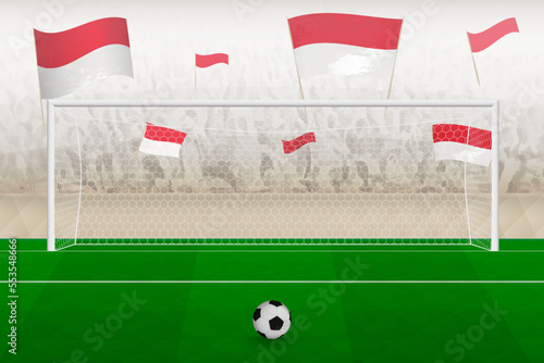 Indonesia football team fans with flags of Indonesia cheering on stadium, penalty kick concept in a soccer match.