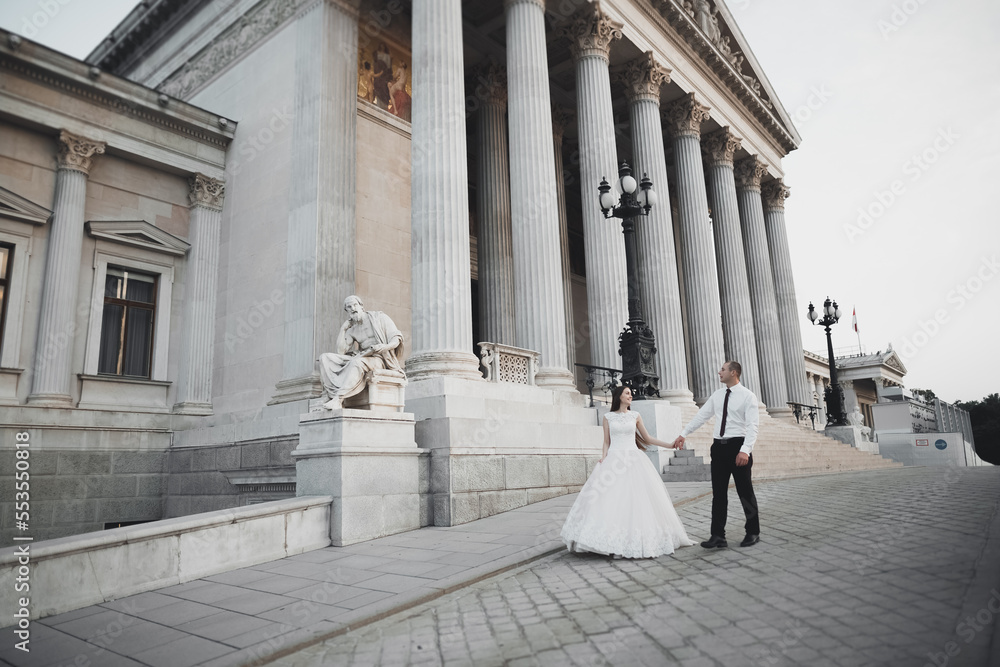 Perfect couple bride, groom posing and kissing in their wedding day Perfect couple bride, groom posing and kissing in their wedding day
