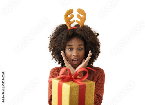 Cute African American young woman in knitted sweater looks exciting with a gift box. Girl smiling, she is happy to receive a present for Christmas festival and happy new year's.