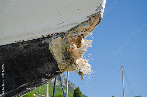 The collision-damaged bow of the fiberglass yacht.