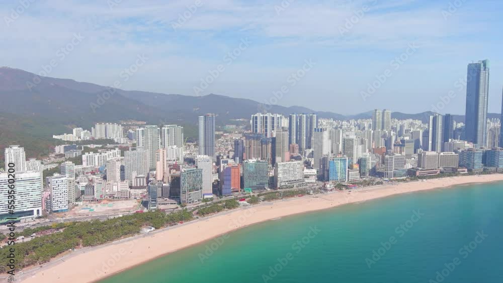 Busan: Aerial view of city in South Korea, skyline with modern high-rise buildings (skyscrapers) and Haeundae Beach, sunny day with blue sky - landscape panorama of Eastern Asia from above Busan: Aerial view of city in South Korea, skyline with modern high-rise buildings (skyscrapers) and Haeundae Beach, sunny day with blue sky - landscape panorama of Eastern Asia from above
