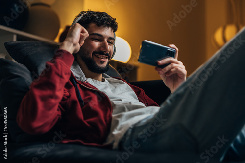 Man is excited about winning the game on his phone