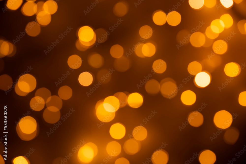 Abstract bokeh background - gold, orange, light blurred glitter lights - 