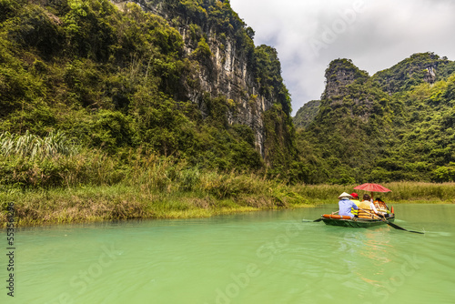 Boating in a lake to view the lush landscape of Ninh Binh; Ninh Binh Province, Vietnam photo