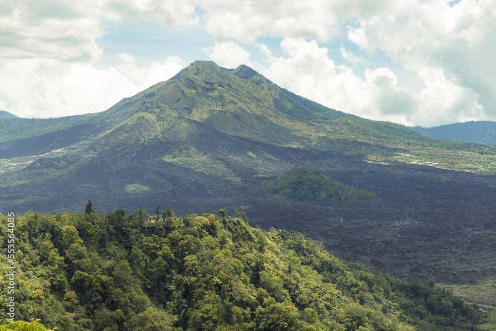 Overview of Mount Batur (Kintamani Volcano) in South Batur with a cloudy sky and lush vegetation; Kintamani, Bangli Regency, Bali, Indonesia Overview of Mount Batur (Kintamani Volcano) in South Batur with a cloudy sky and lush vegetation; Kintamani, Bangli Regency, Bali, Indonesia