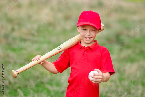 A Happy child with baseball bat on nature concept in park