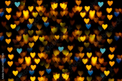Perfect yellow-orange-blue heart-shaped bokeh for festive background of New Year, Christmas, Valentine's Day, birthday
